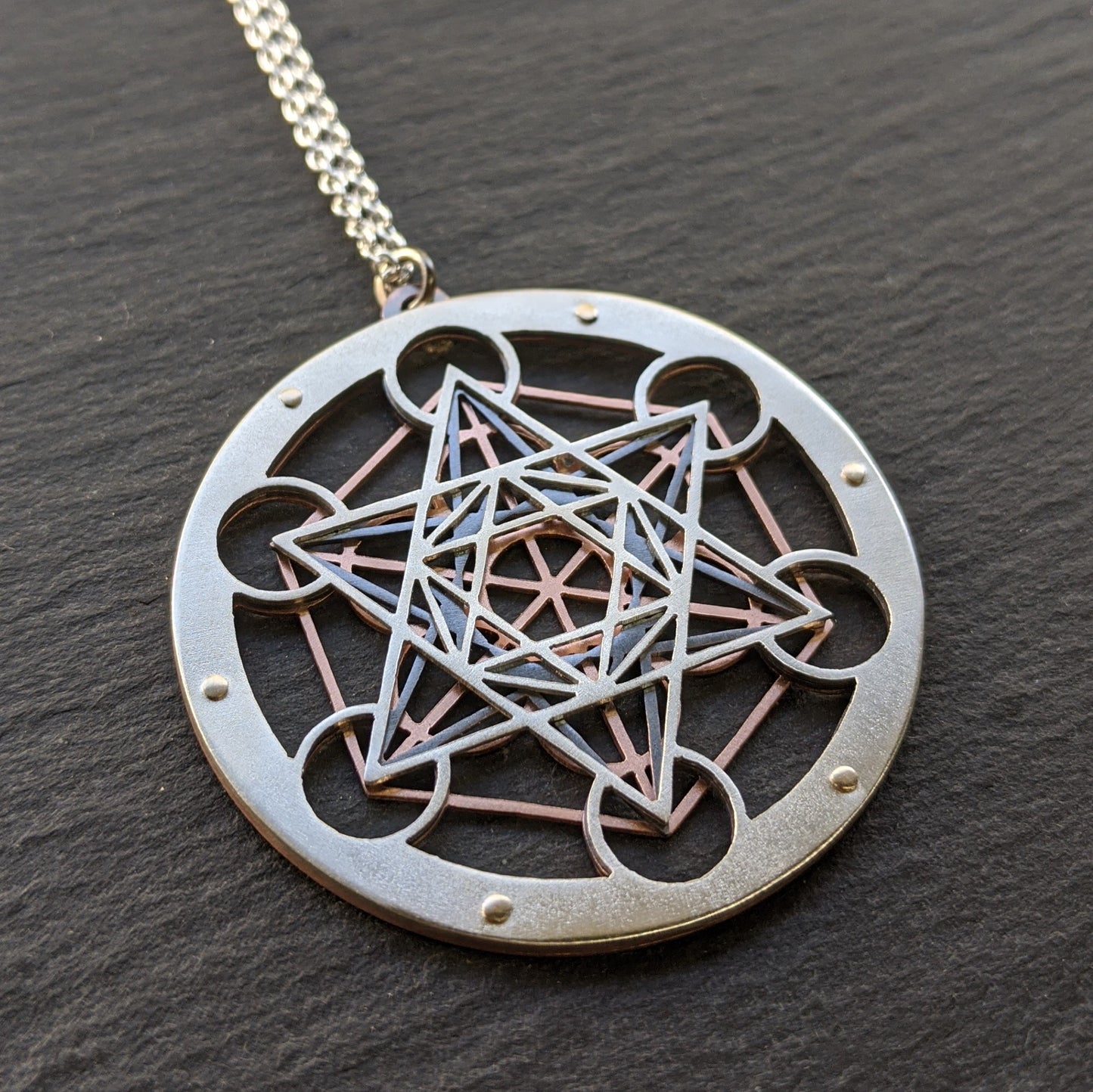 Large Metatron's Cube Pendant by Jean Burgers Jewellery. Handcut from sterling silver and copper, with gold rivets.